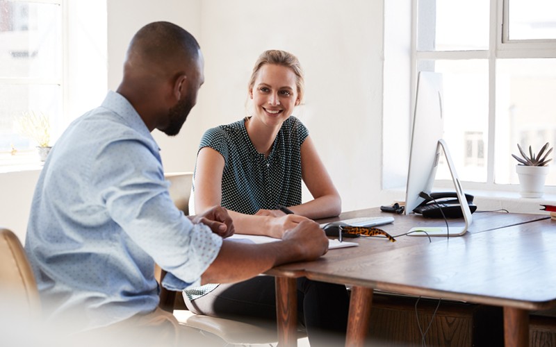 Business professionals review data on a tablet computer