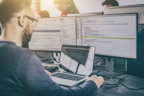 Man typing at computer