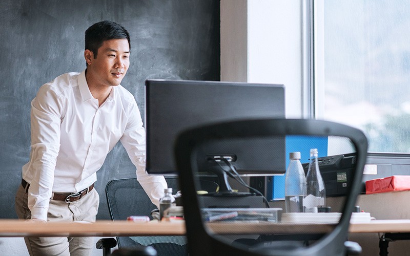 Man looking at the computer monitor