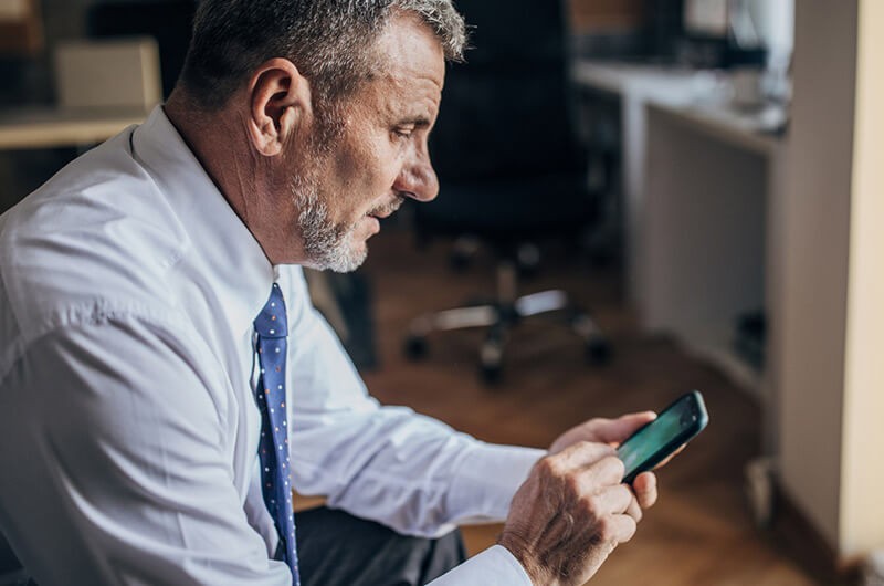 Close up of government official using smart phone