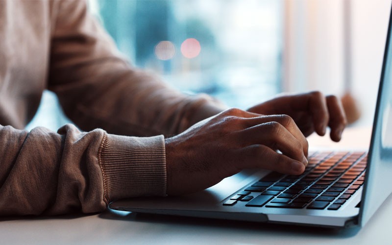 Close up of hands typing on laptop computer 